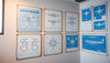 A wall adorned with technical blueprint posters of an airbus