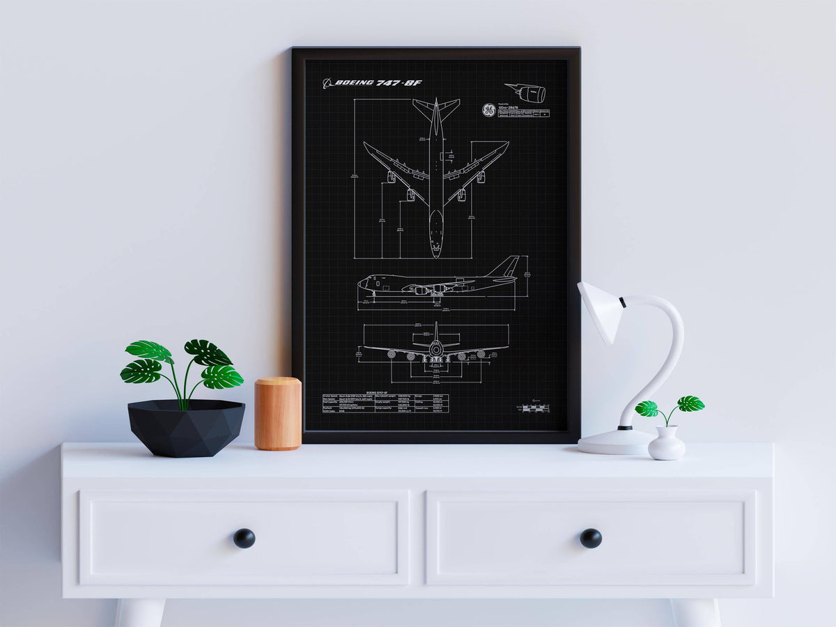 Boeing B747-8F Portrait Blueprint Poster by FlyKit displayed on a white desk with small plants and a lamp
